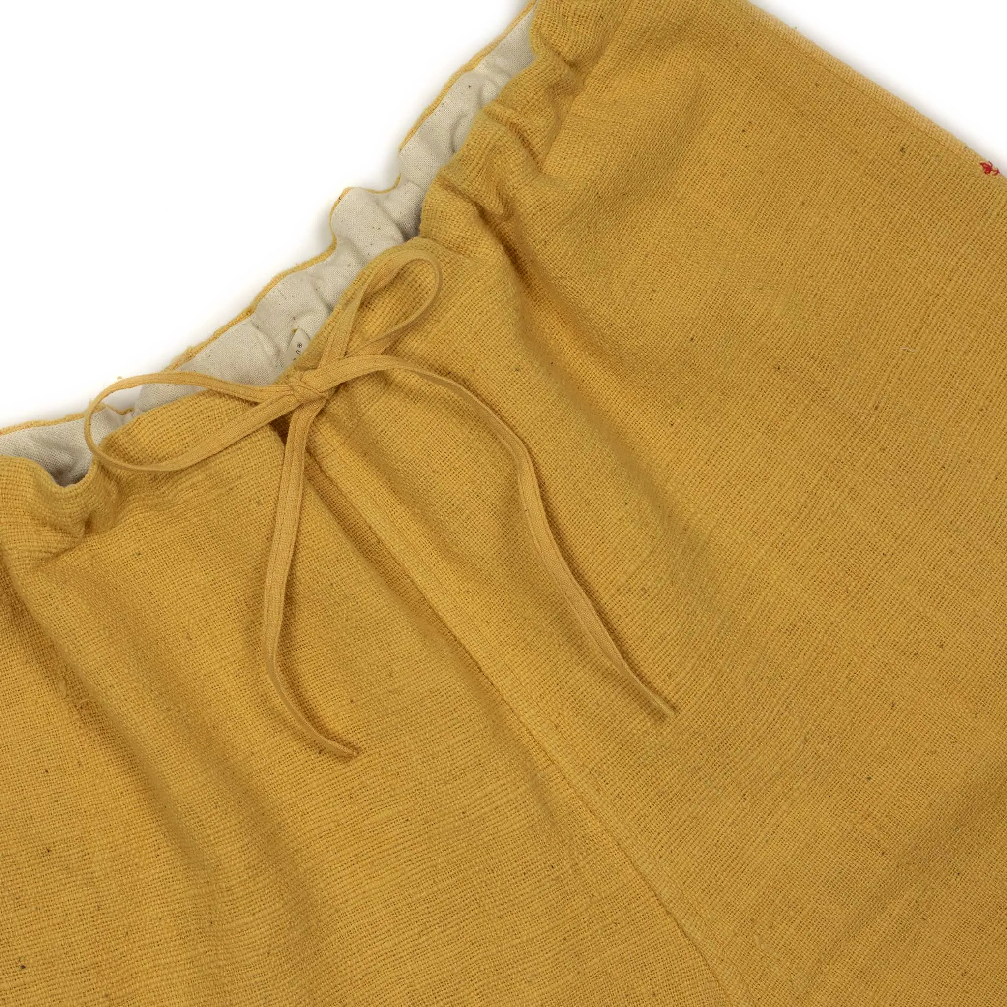 Drawstring tapered trousers in mango yellow cotton basketweave