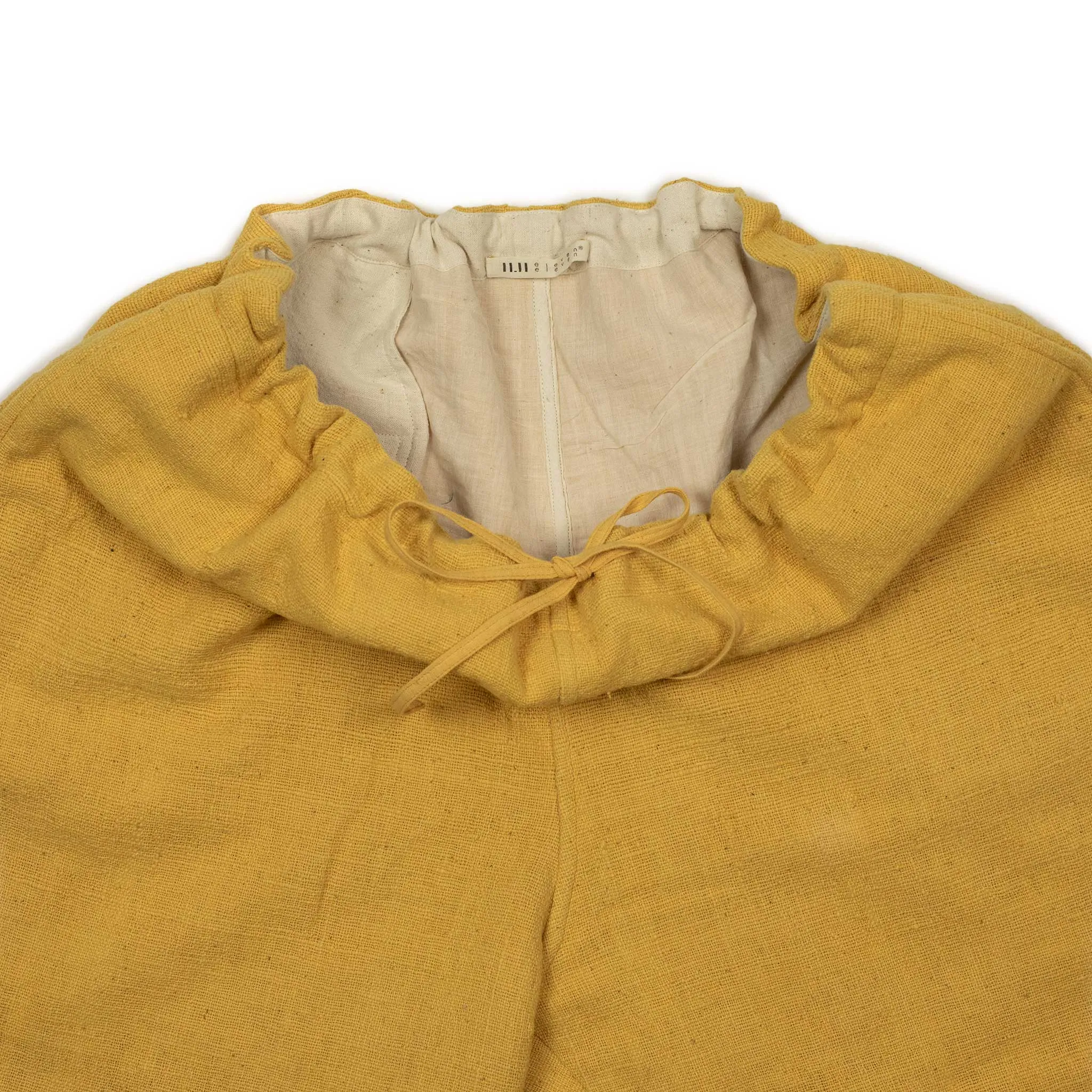 Drawstring tapered trousers in mango yellow cotton basketweave